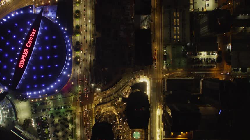 Vehicles travel on a city road at night