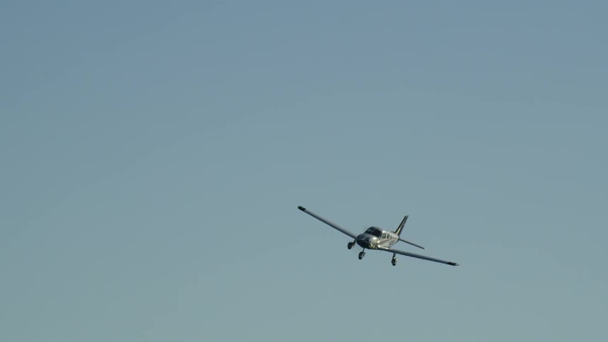 Airplane flies in the clear blue sky