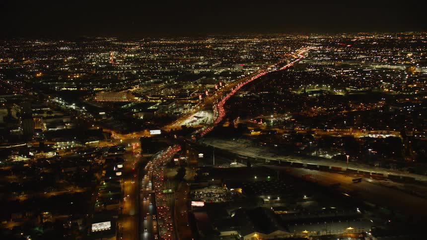 Vehicles travel on a highway at night