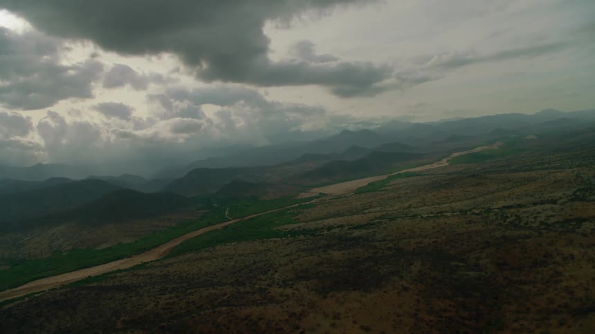 Clouds float above a mountain landscape