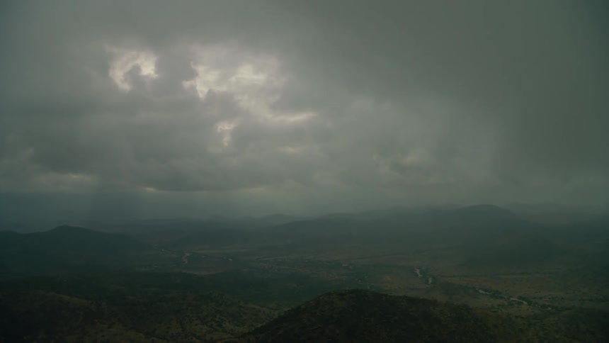 Clouds float above a mountain landscape