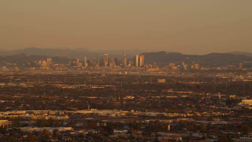 A cityscape is shown at sunset