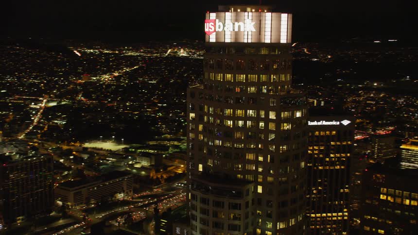 Tall city buildings illuminate the night sky