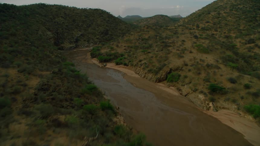Shallow water flows down a narrow valley stream