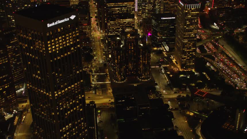 Vehicles travel on a city road at night