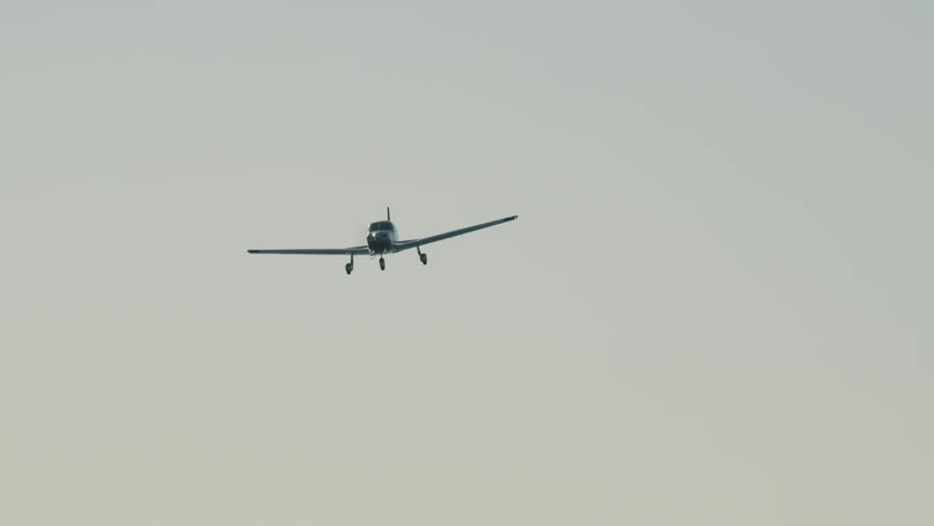 Small plane flying in the open sky