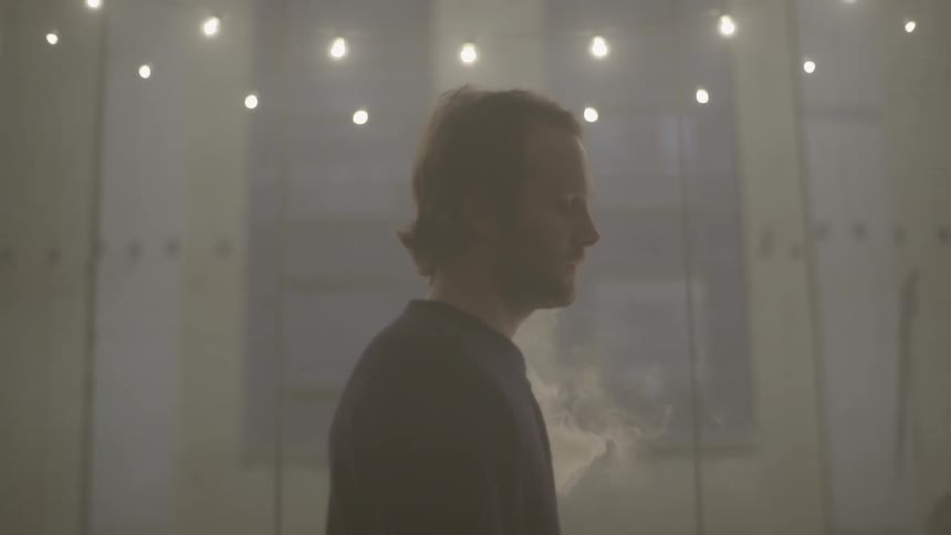 Smoke billows from behind a man