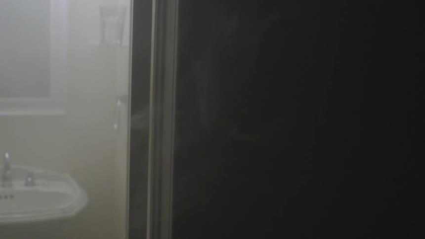 Smoke wafting out of a bathroom