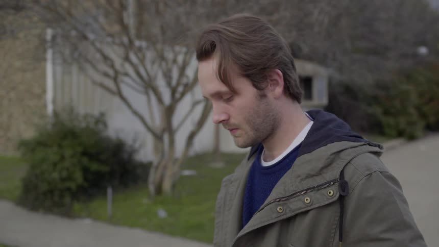 A young man walking outside on a cold day