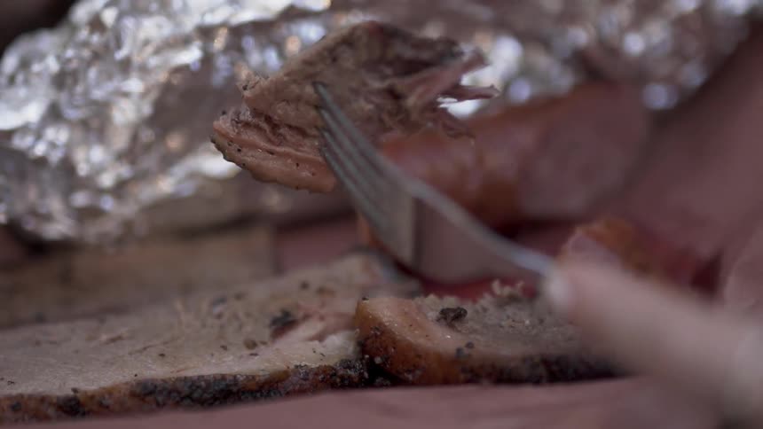 A man cuts into a plate of meat