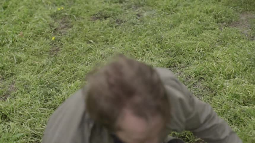 A man is falling in a field