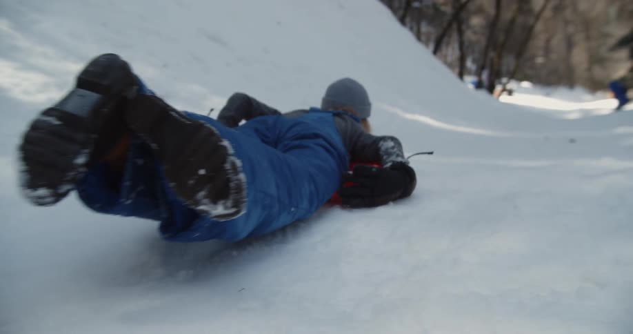 A child sleds down a hill