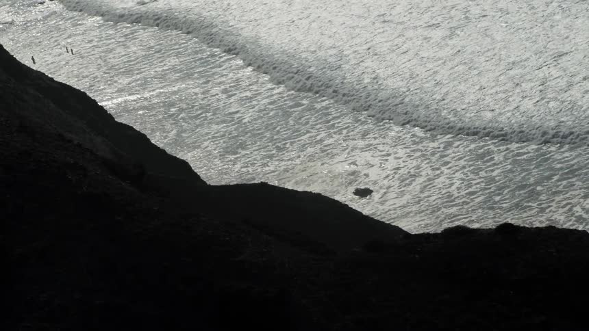 Foamy waves roll into shore
