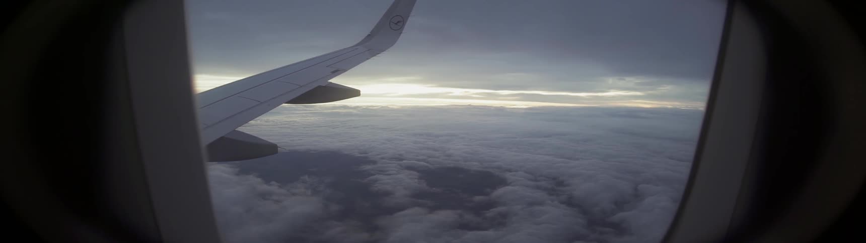 A plane flies above the clouds