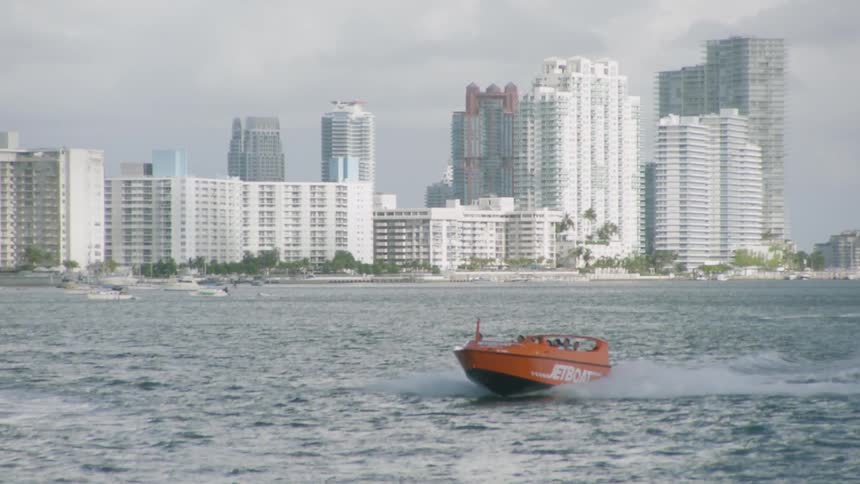 Orange boat cruises on the open water