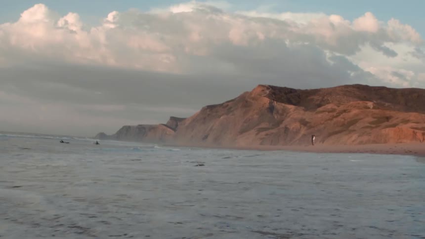 Ocean waves wash ashore a sandy beach