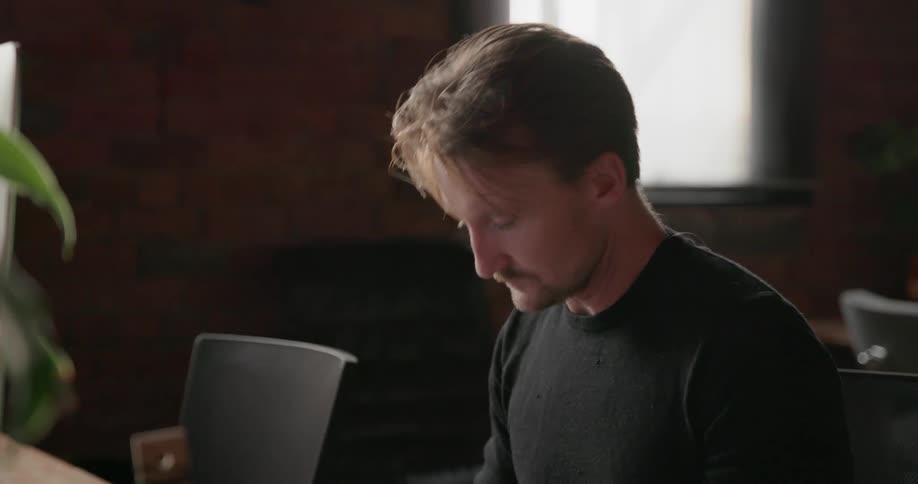 Man works on a computer in an office
