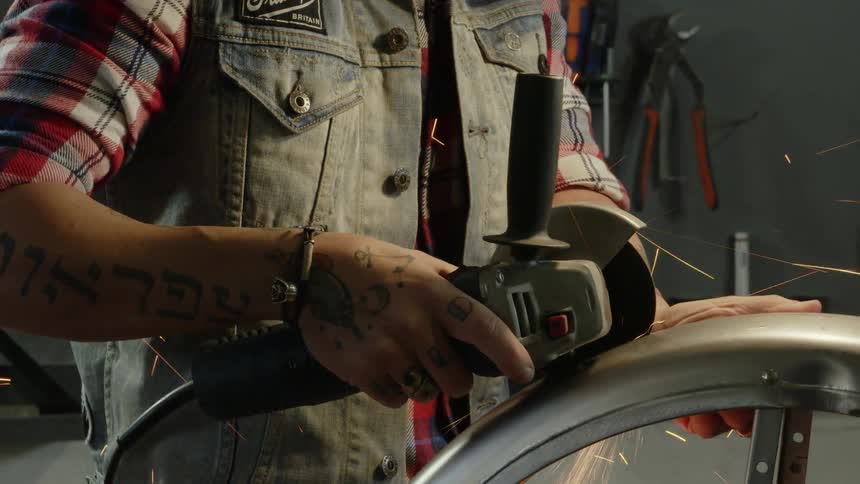 A man uses power tools in a workshop