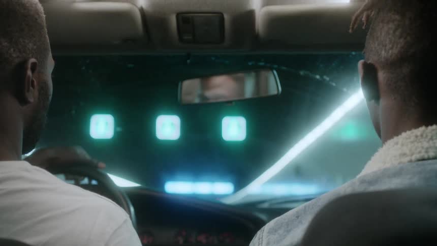 Two men drive down a tunnel together