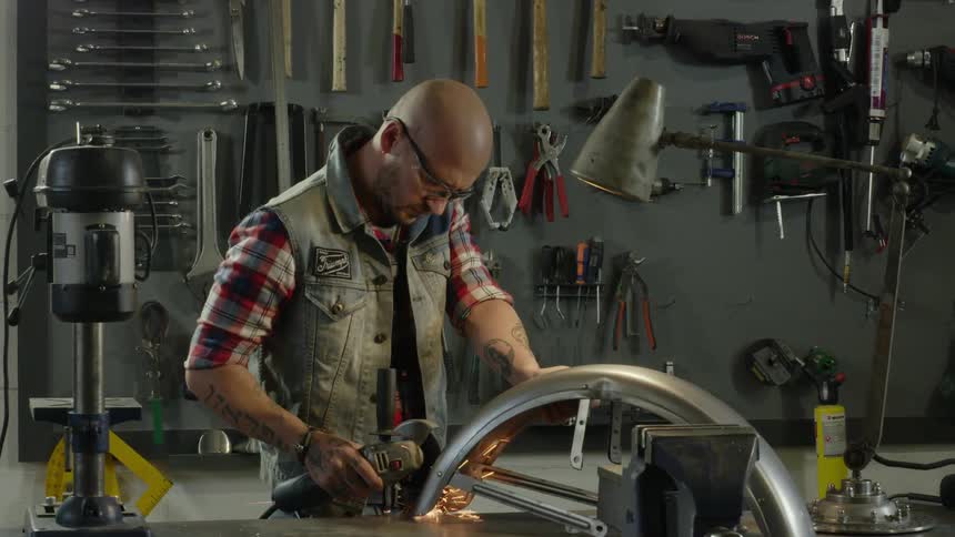 A man uses power tools in a workshop