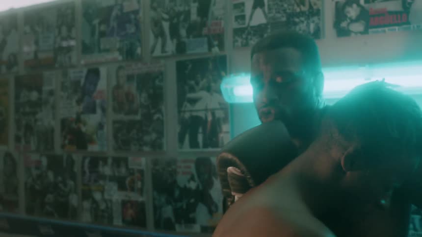 Two men fight in a boxing ring