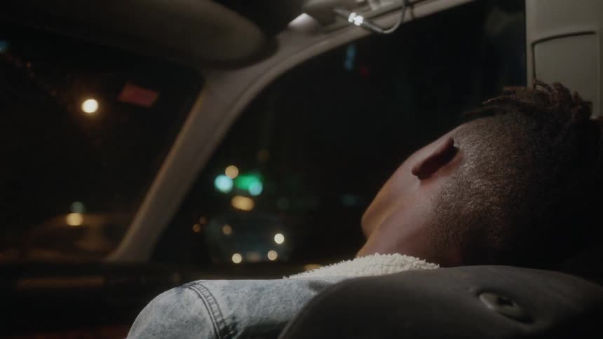 A man sleeps while riding in a car