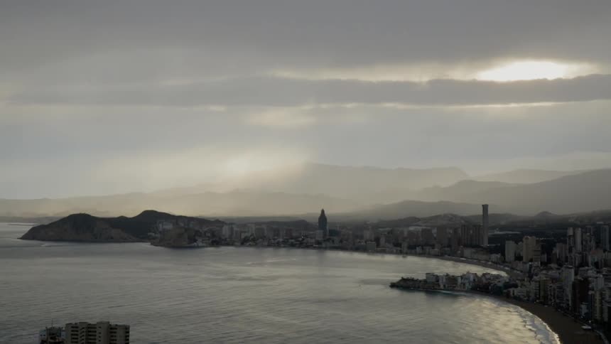 The coast is lined with buildings at sunset