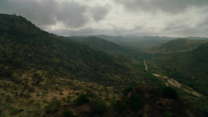 Clouds float over rural mountains