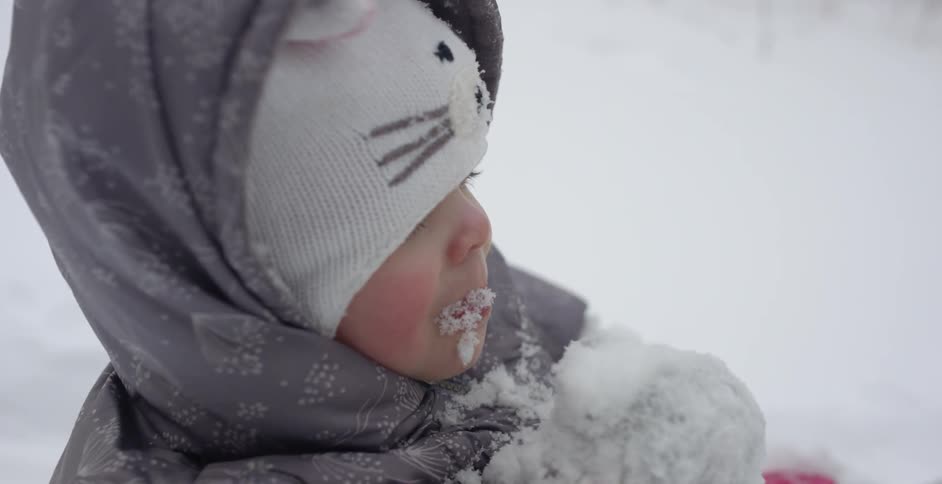 A child eats some snow