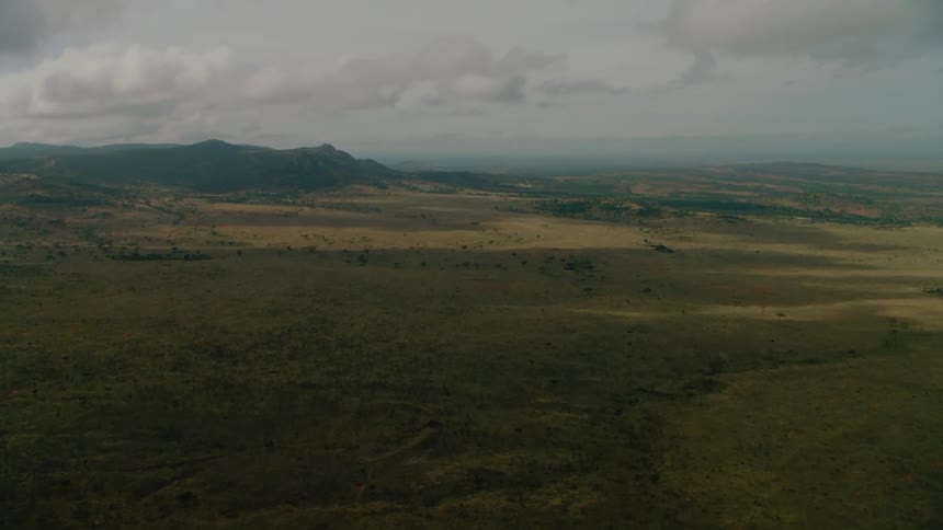 Clouds are casting shadows on a remote landscape during the day