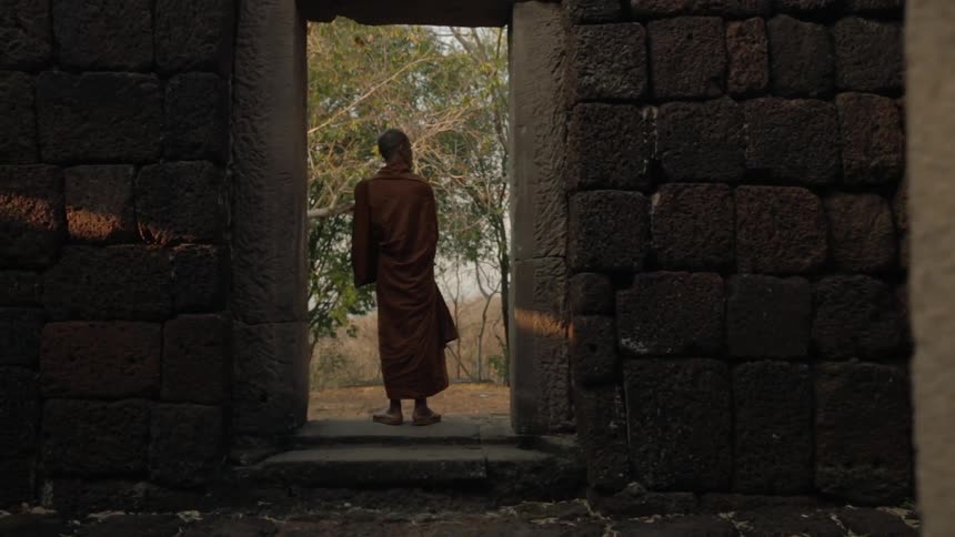 Monk stands in a doorway