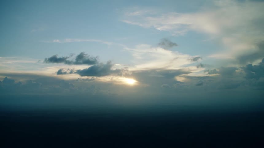 Clouds float under a blue sky