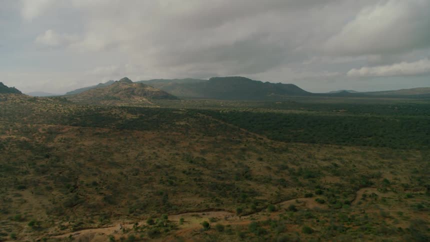Clouds float above a rural mountain landscape