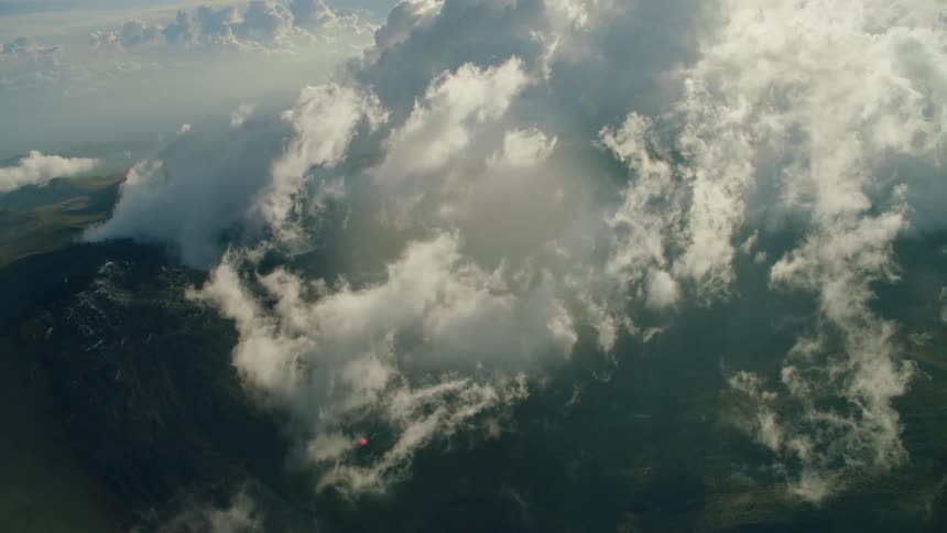 Clouds float above mountains
