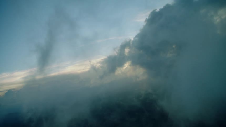 Flying through the clouds at sunset