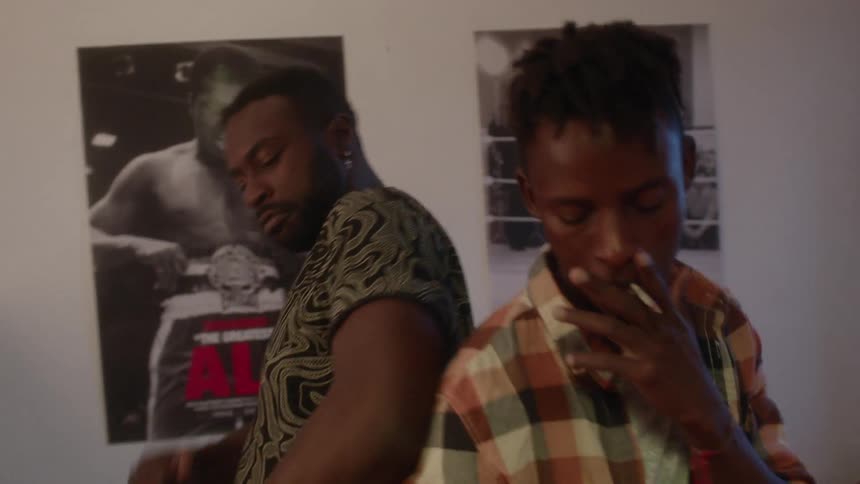 Two men dance together in the room