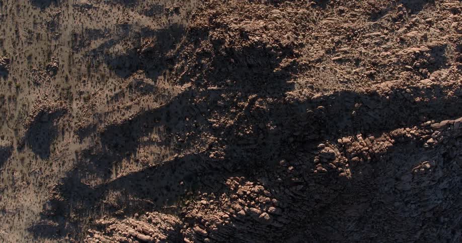 The ground below is covered with rocks and hills