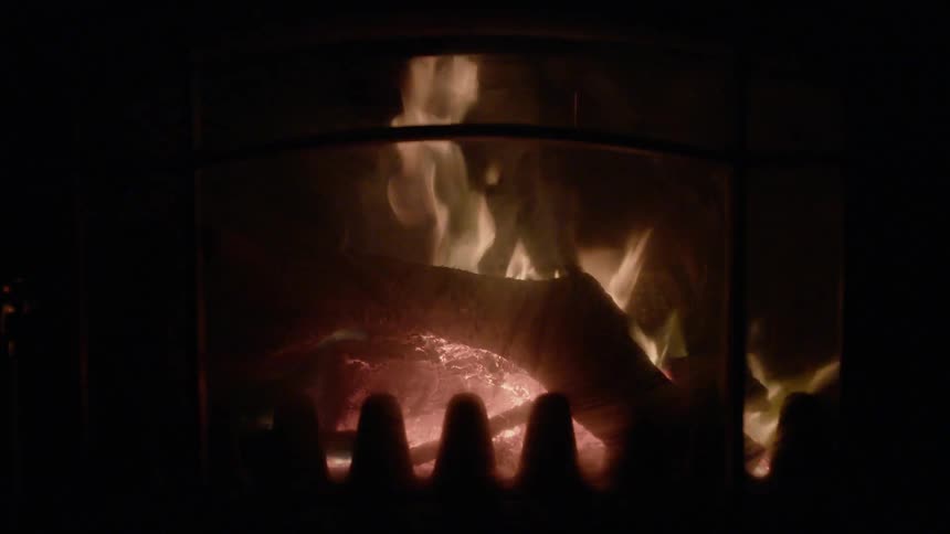 The fire is burning logs in the fireplace