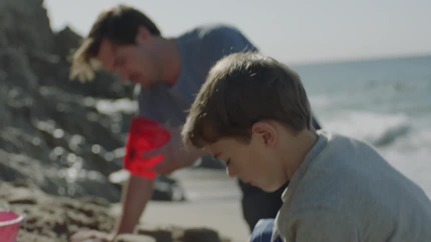 A child is playing in the sand