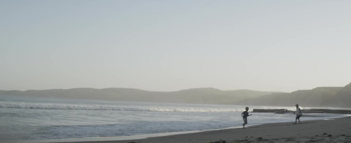 A boy plays in the surf