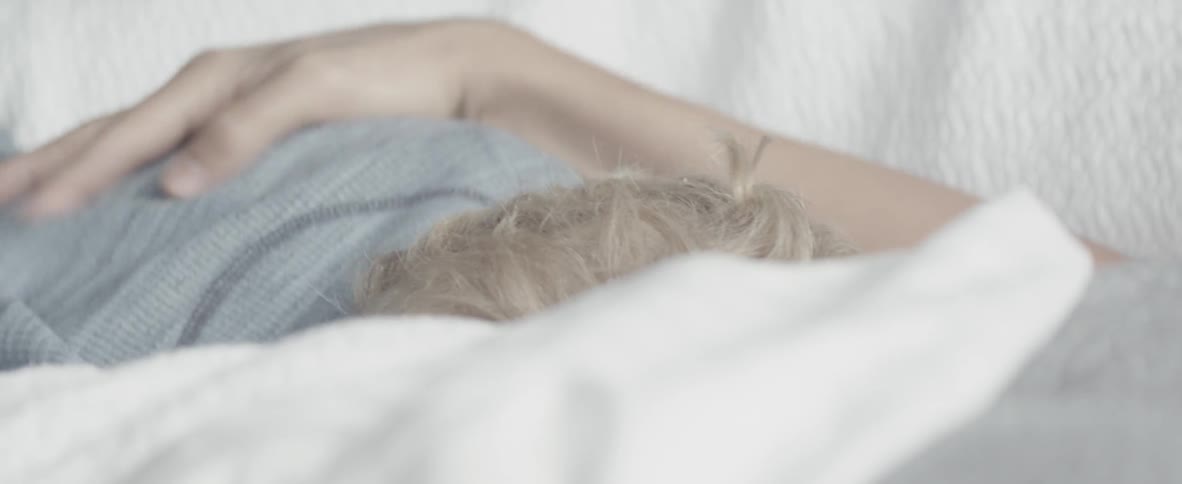 Parents comfort their child in bed