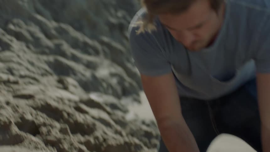 A man is building a sand castle