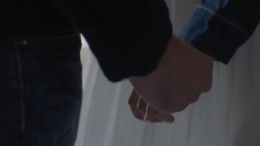 A couple is holding hands