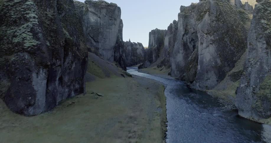 A river flows between rock formations