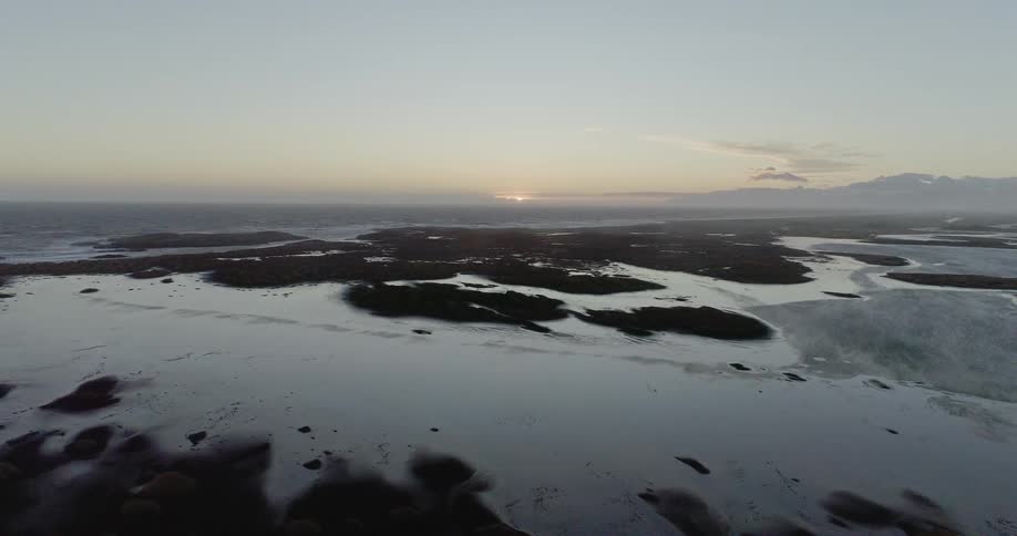 The sun sets over a beach
