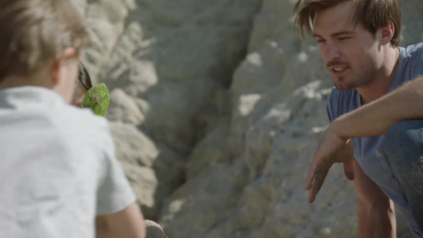 A child is playing in the sand