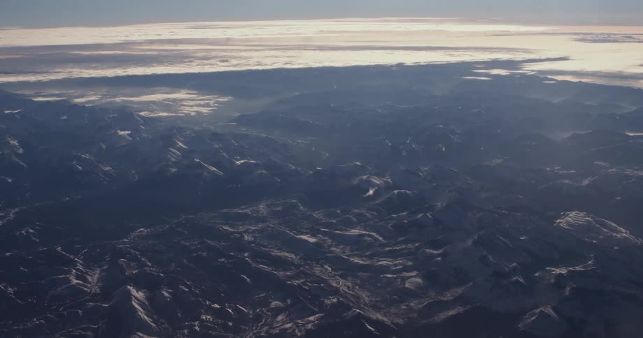 The hills below are covered with fog at sunset