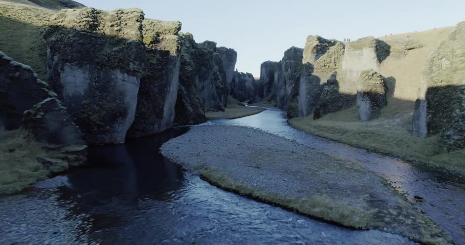 The stream runs in the middle of these cliffs