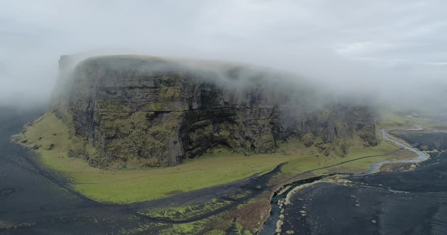 Clouds float above a mountain