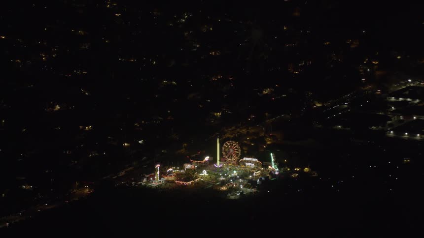 Fireworks explode above an amusement park